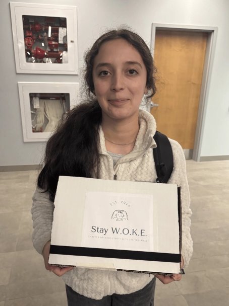 Espe holding the finished Stay W.O.K.E. prototype box at the final demo
