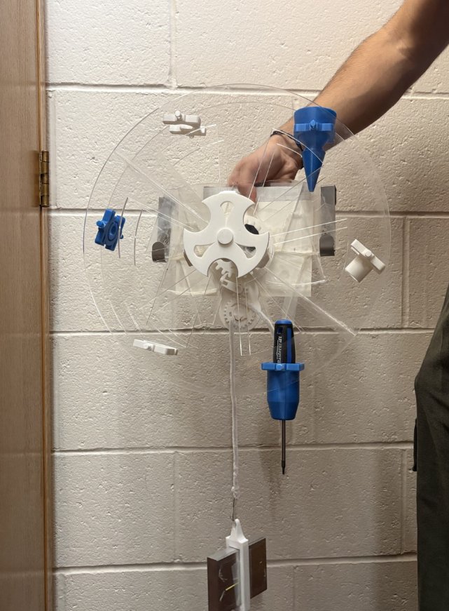 Tool Turret prototype mounted on a wall, showing the 3D-printed gear and wheel mechanism holding tools